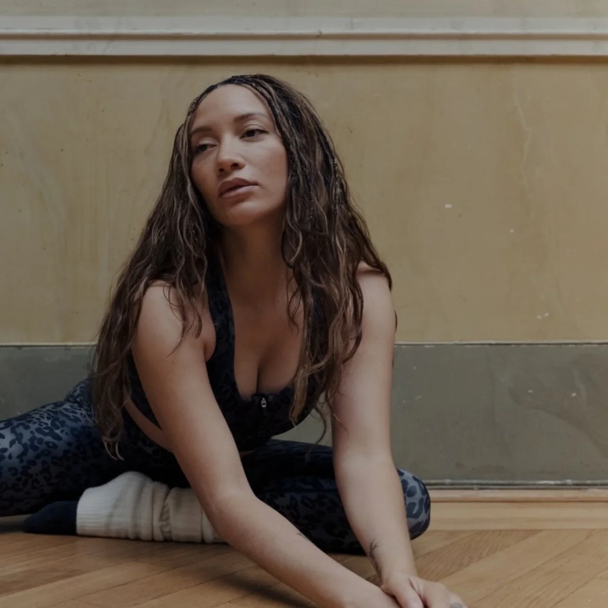 The Royal Ballet School dancer stretching on a studio floor
