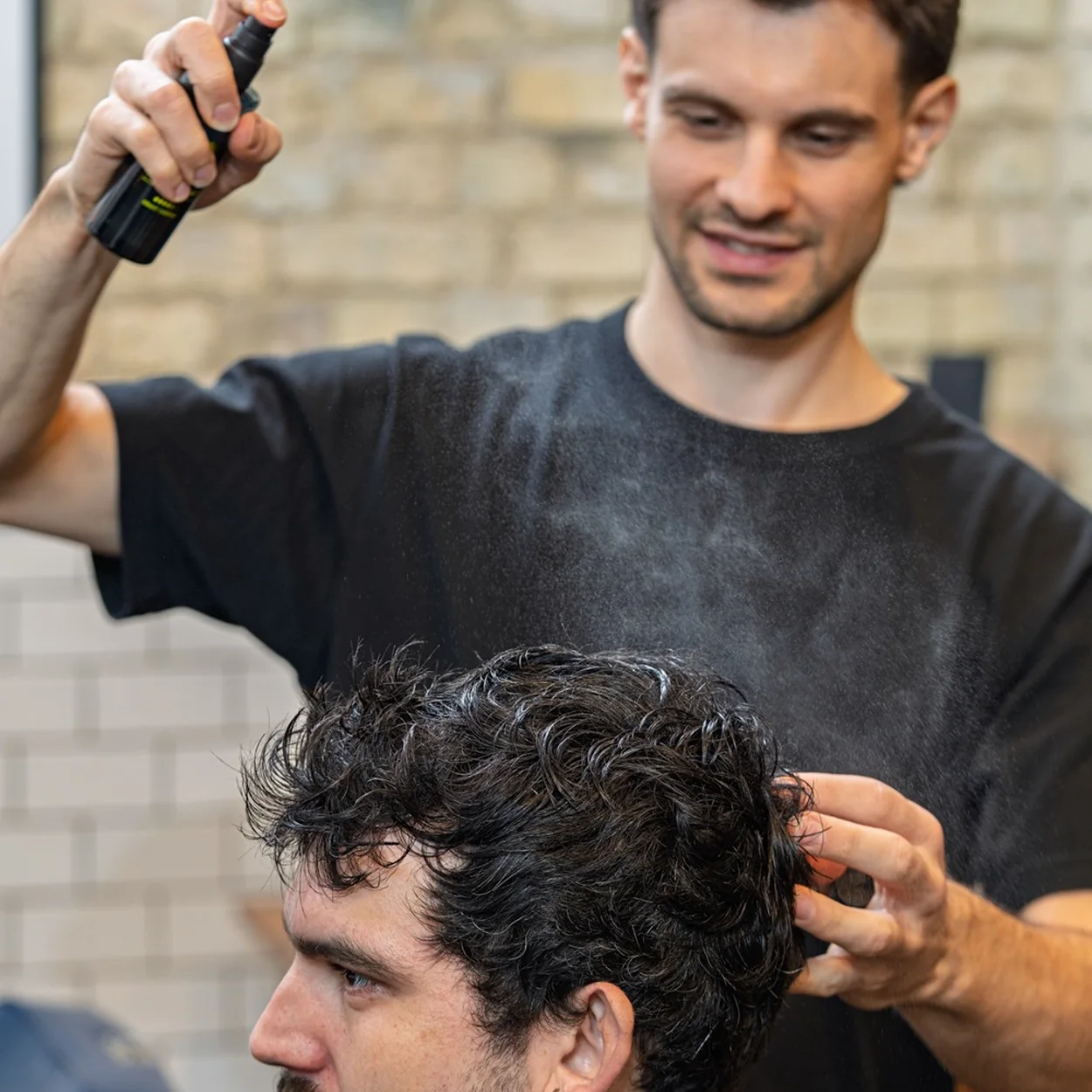 Ruffians barber styling curly hair at the Covent Garden shop