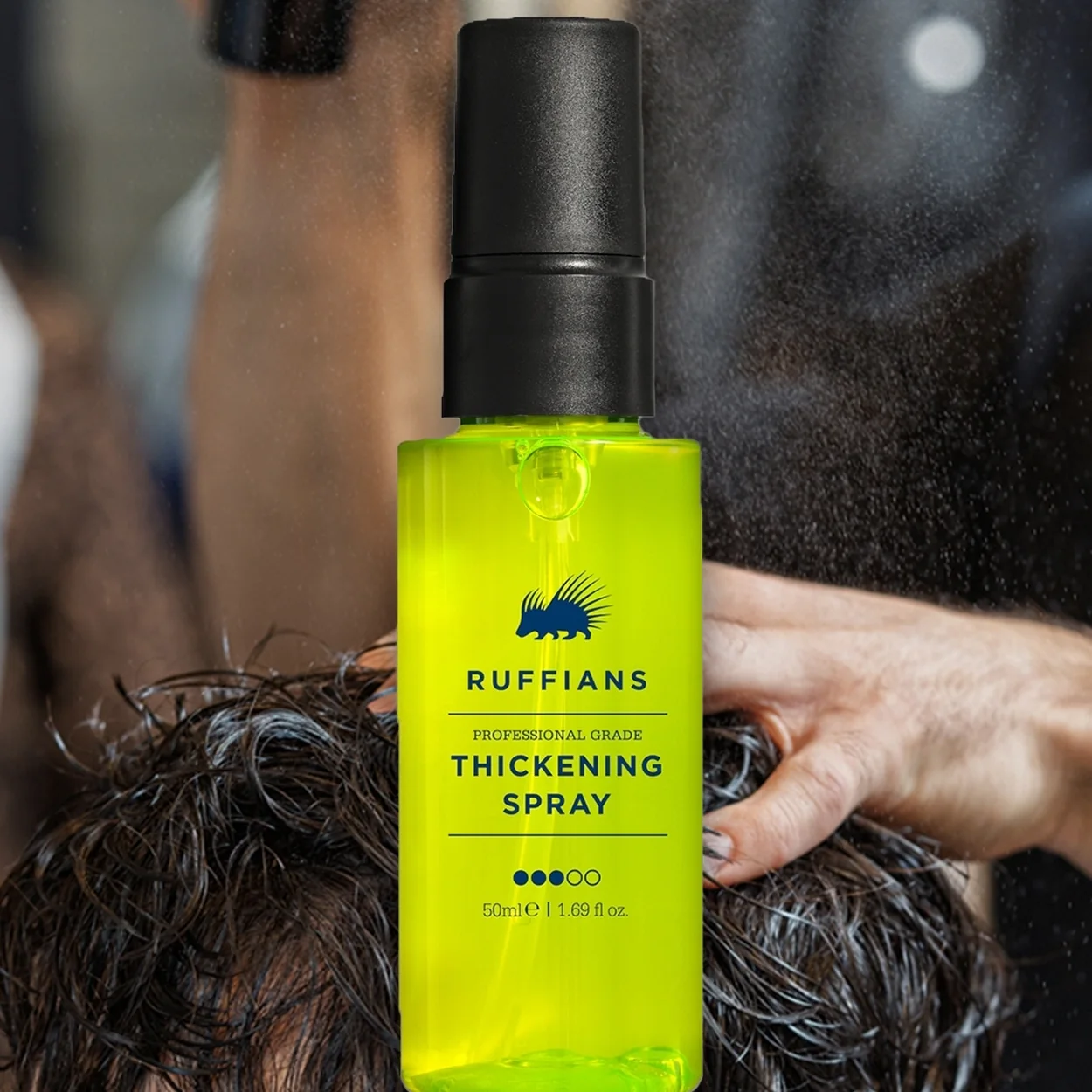 Ruffians Thickening Spray being applied during a haircut