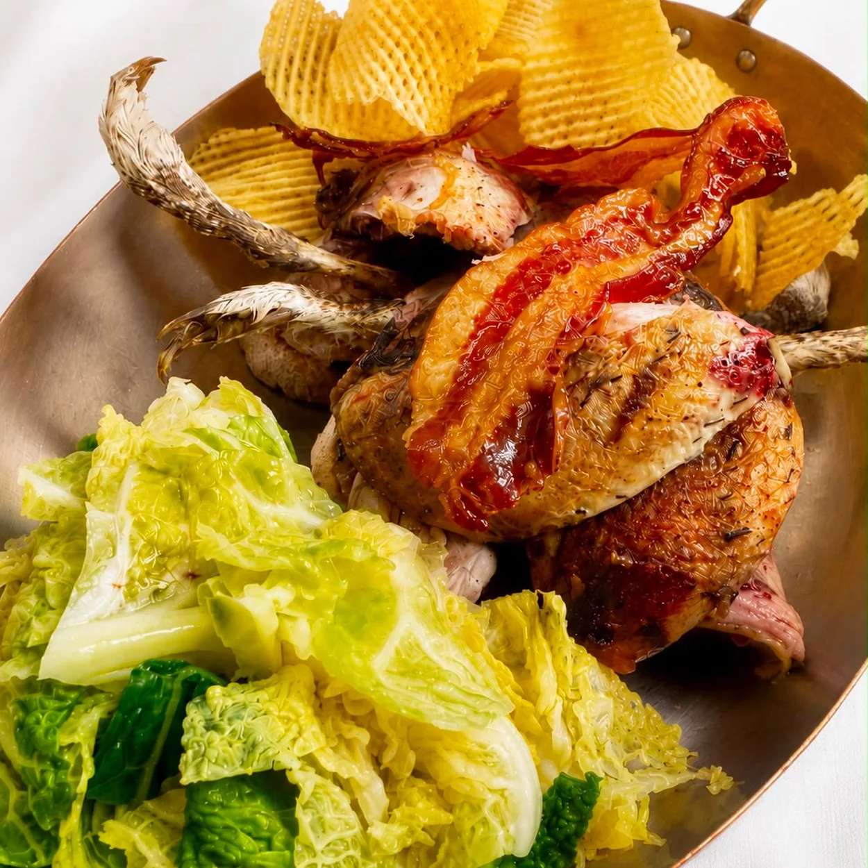 Rules roast game bird with game chips and savoy cabbage