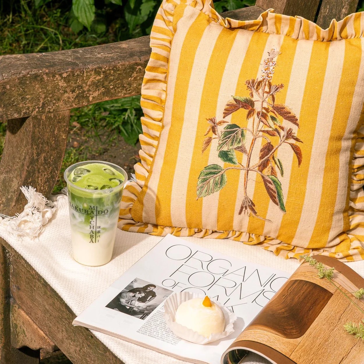 Sakurado mochi and iced matcha on a garden bench