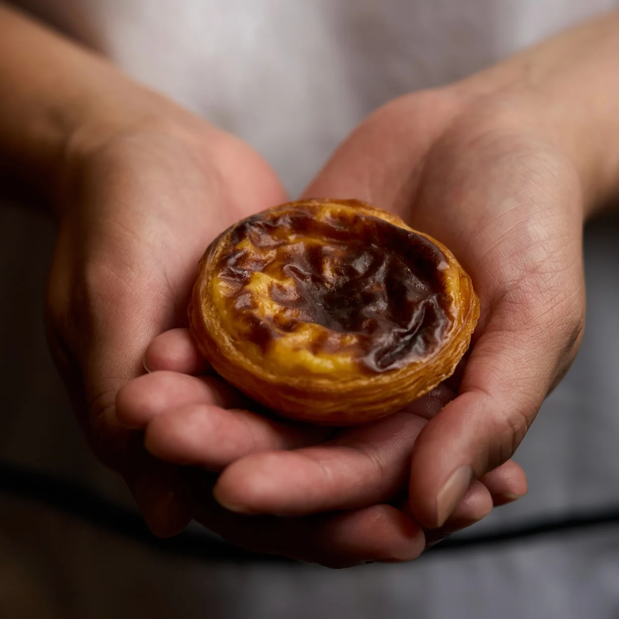 Santa Nata warm pastel de nata held in cupped hands