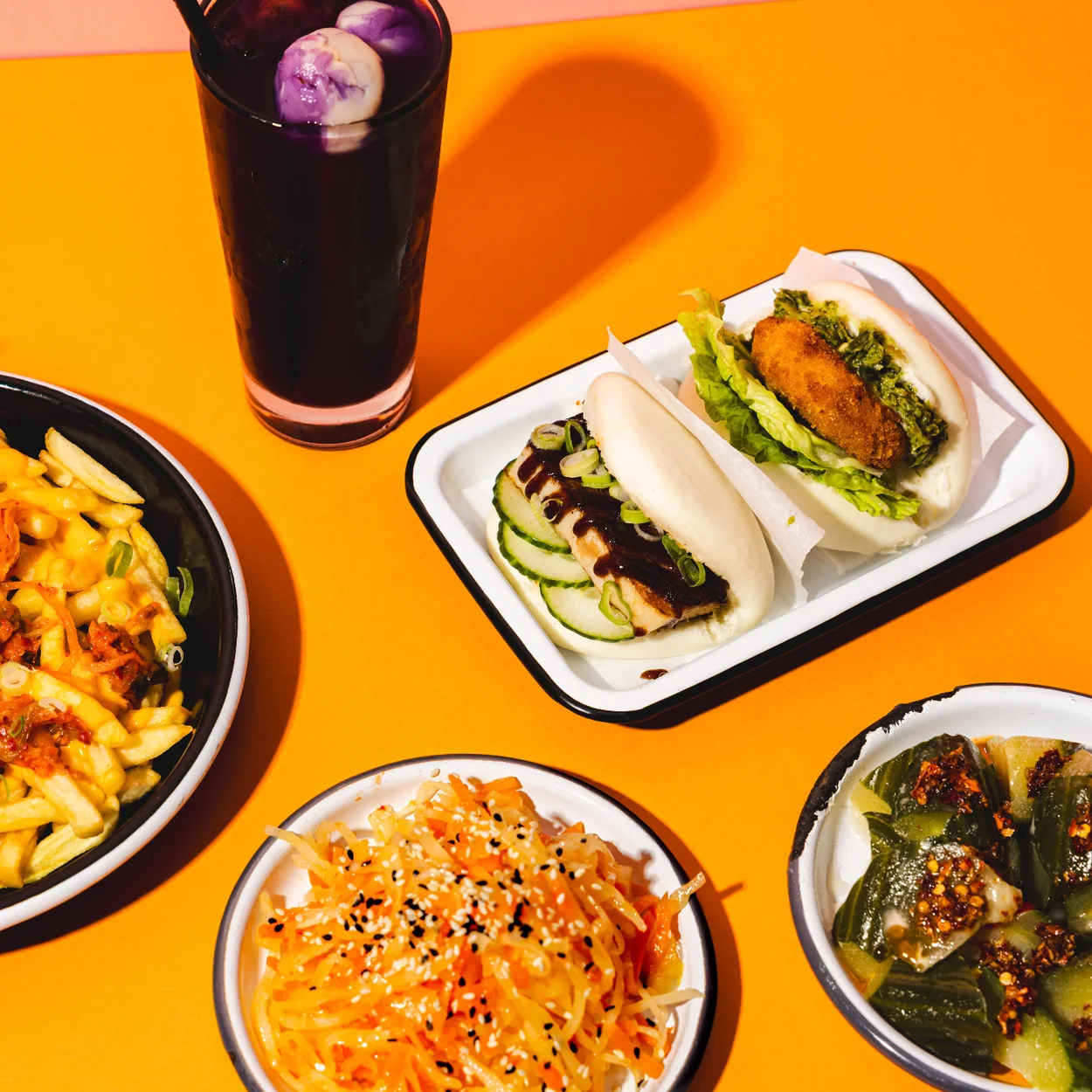 Seven Dials Market street food dishes, bao buns and fries with a cold drink