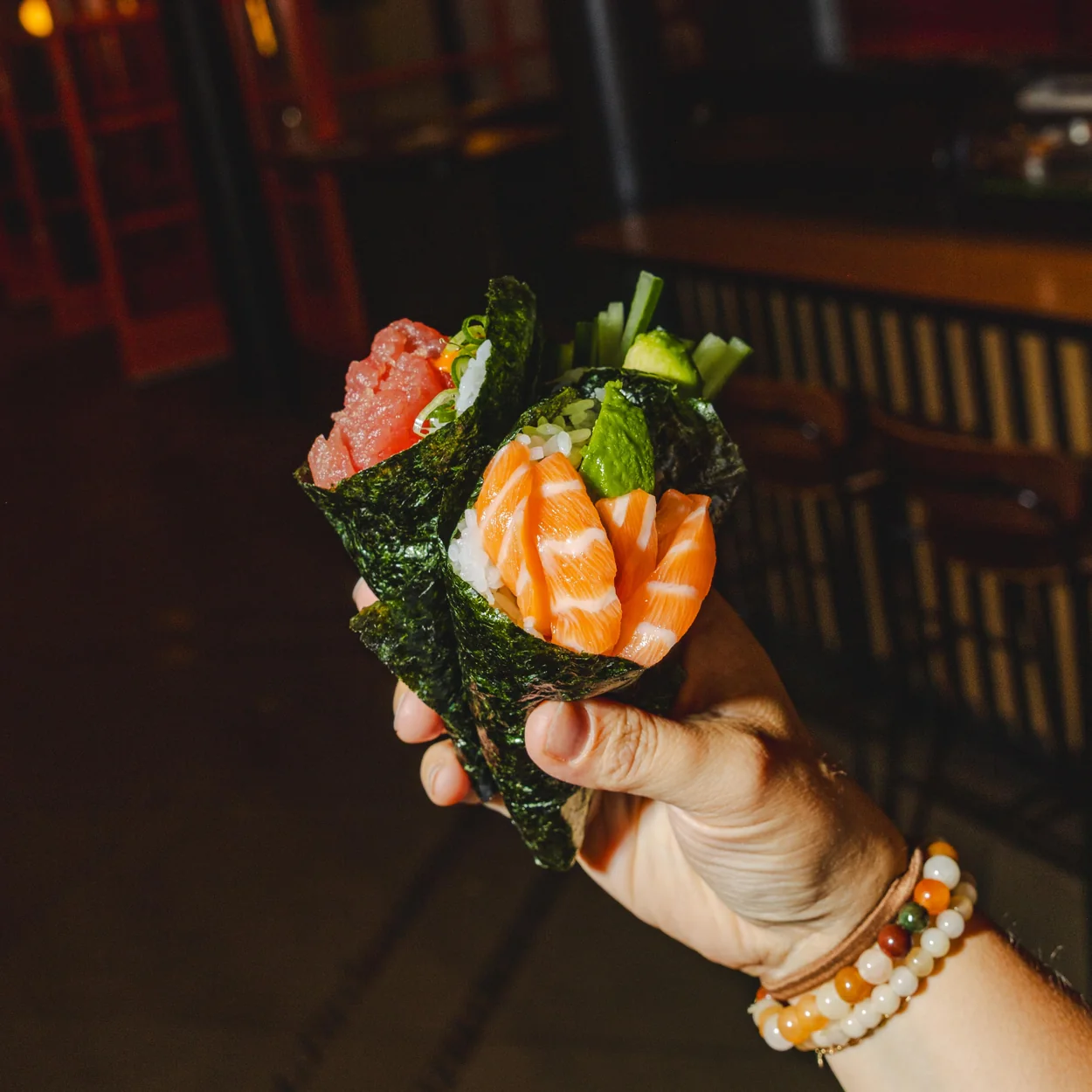 Seven Dials Market salmon hand roll served at a stall in the food hall