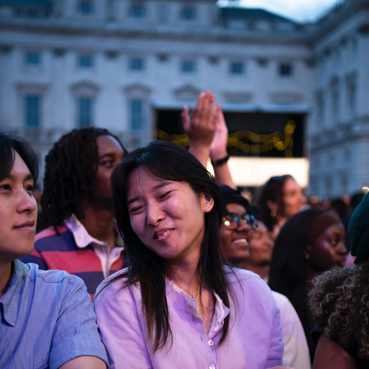Audience at a Somerset House courtyard event with the stone facade behind