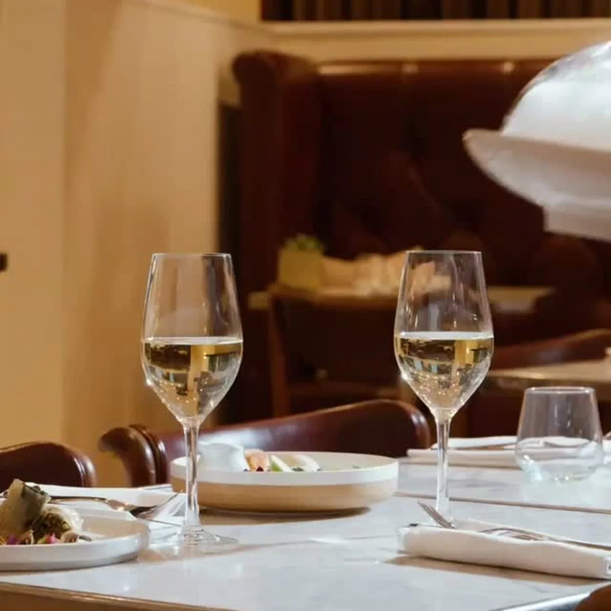 St Martins Lane restaurant table with glasses of wine