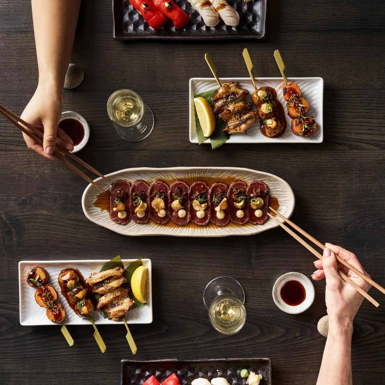 Sticks'n'Sushi table of grilled sticks, nigiri and sushi rolls