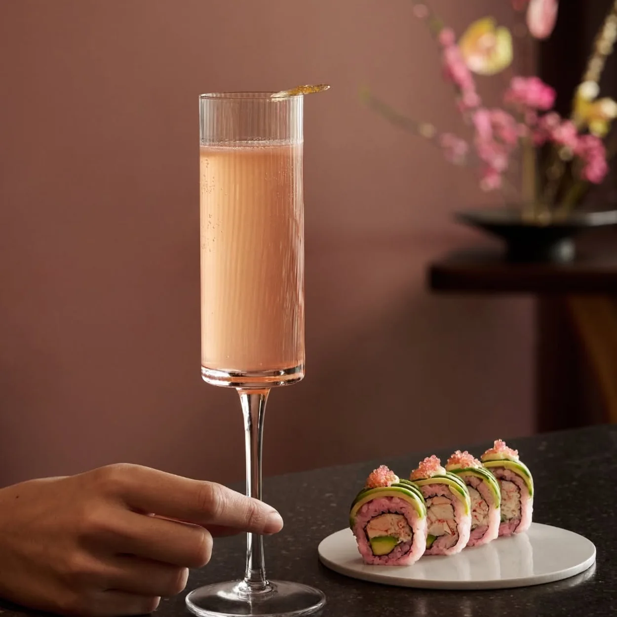 Sticks'n'Sushi cocktail served with a plate of sushi rolls