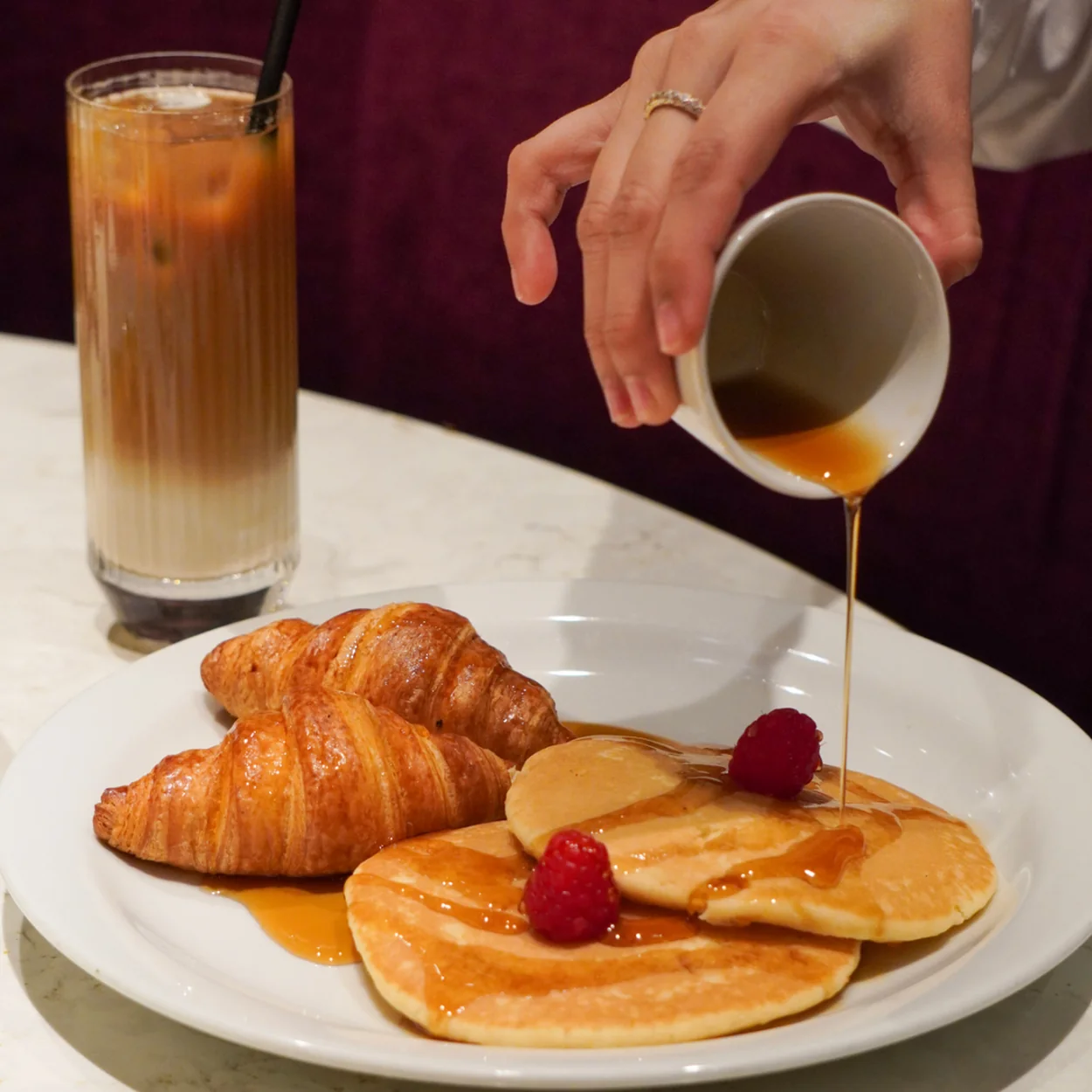 Strand Palace breakfast of pancakes and croissants with iced coffee
