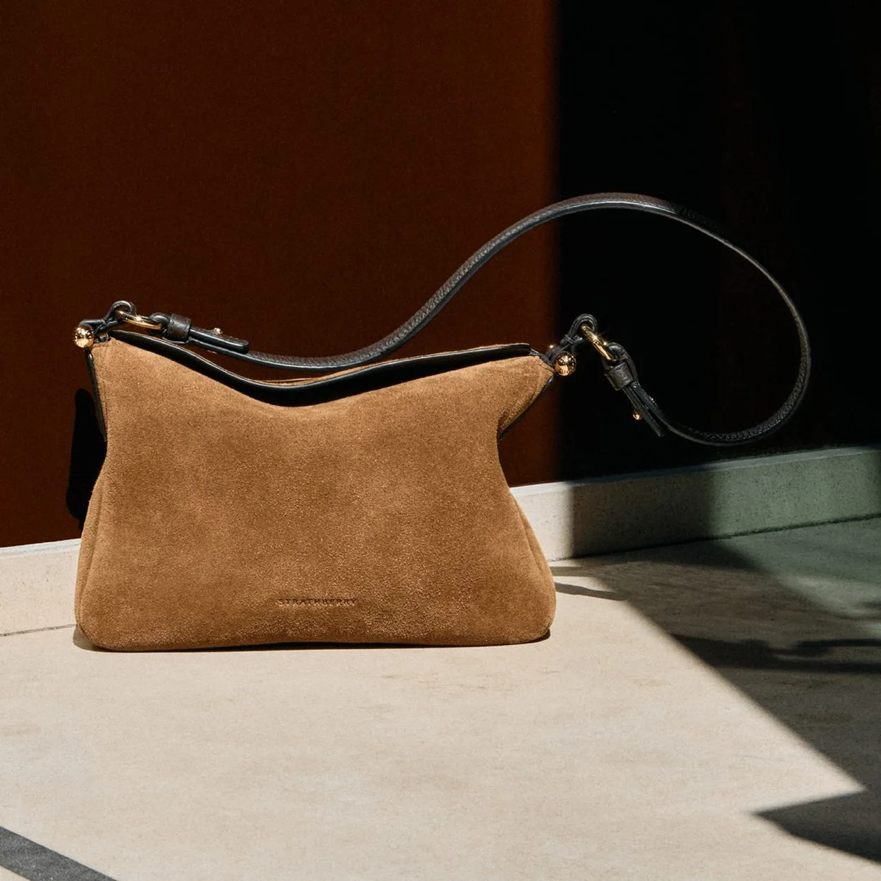 Strathberry tan suede shoulder bag in natural light