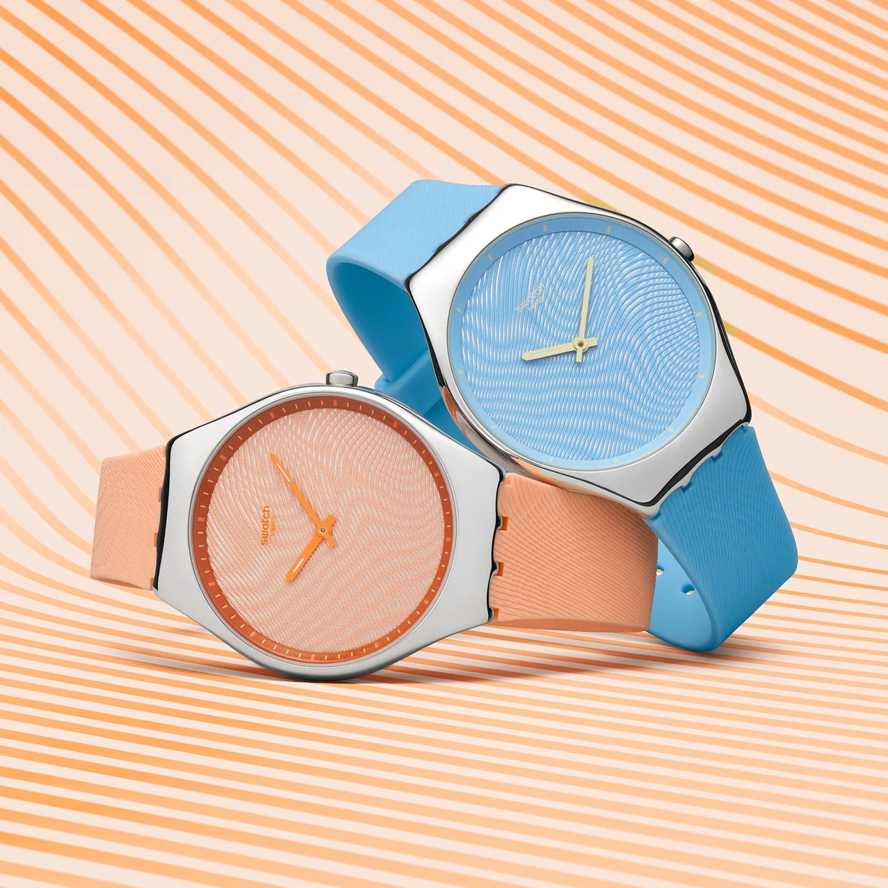 Swatch Skin watches in peach and blue
