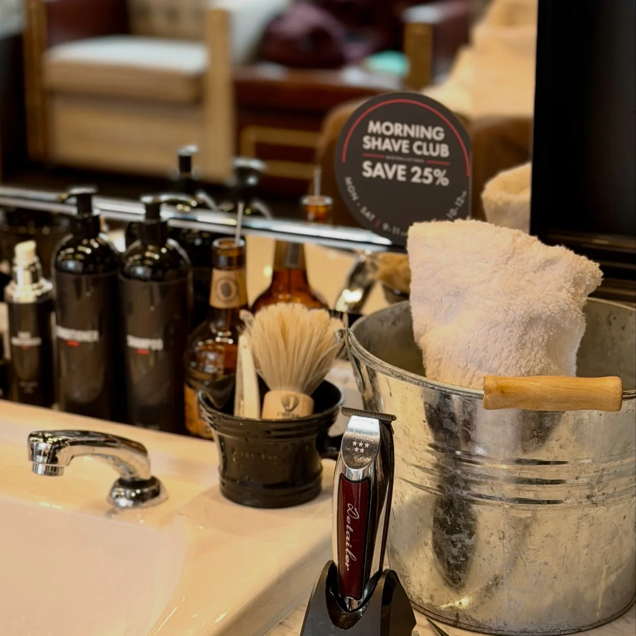 Ted's Grooming Room barber station with shaving brushes, razor and hot towels