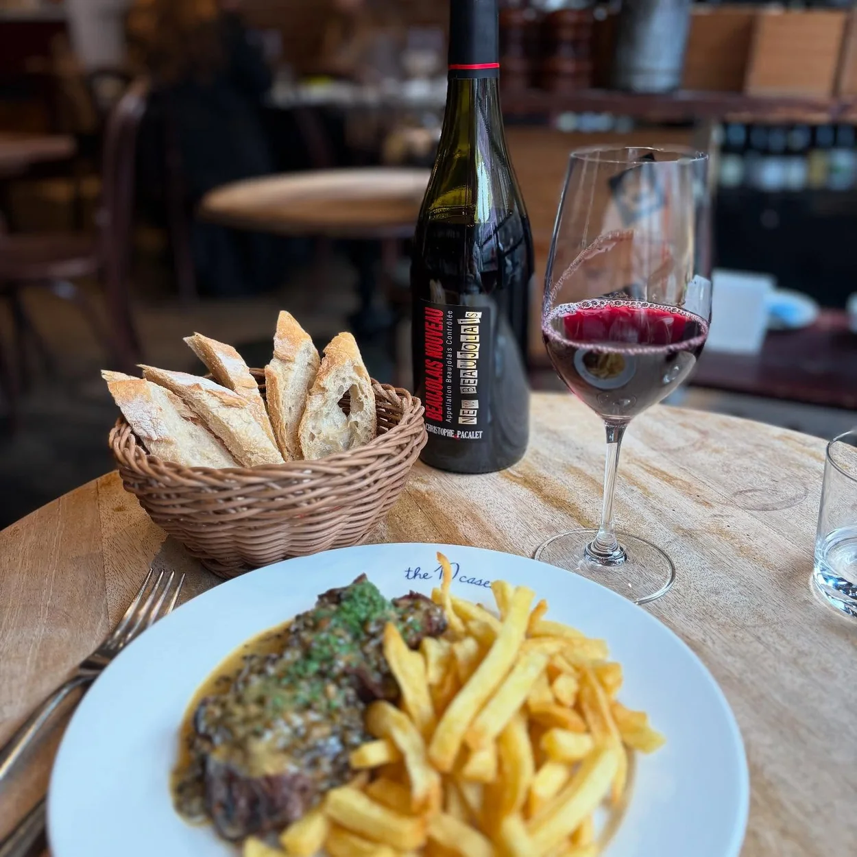The 10 Cases bistro lunch of steak, chips and a glass of red wine