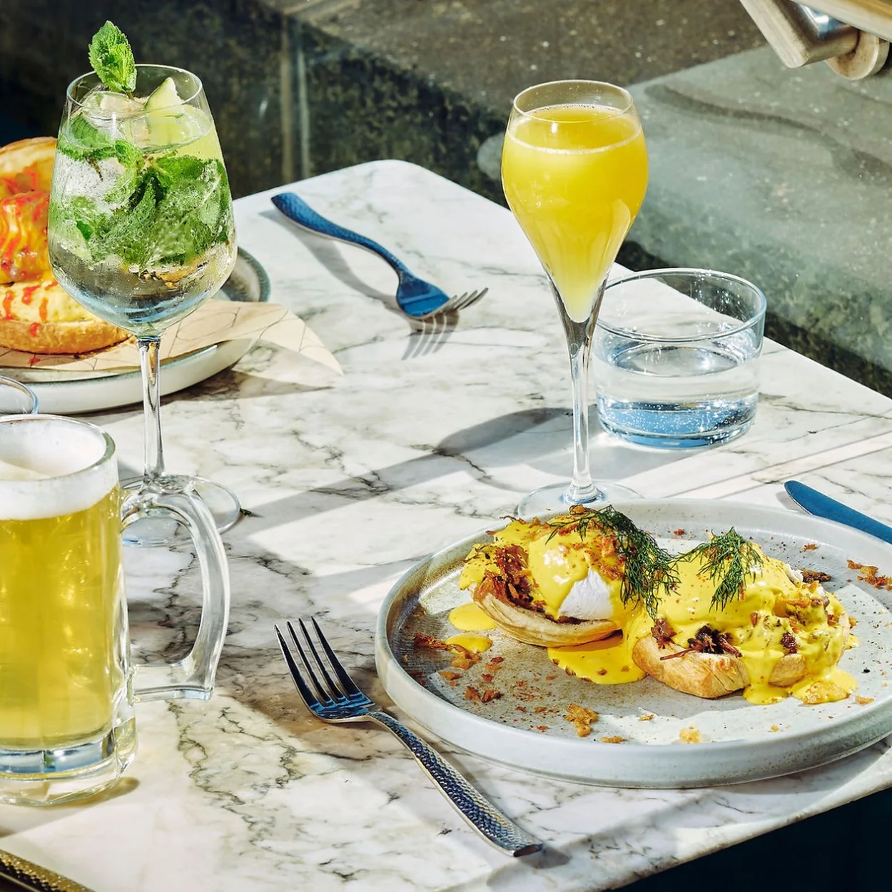 The Alchemist St Martin's Lane brunch plate with eggs and a mimosa