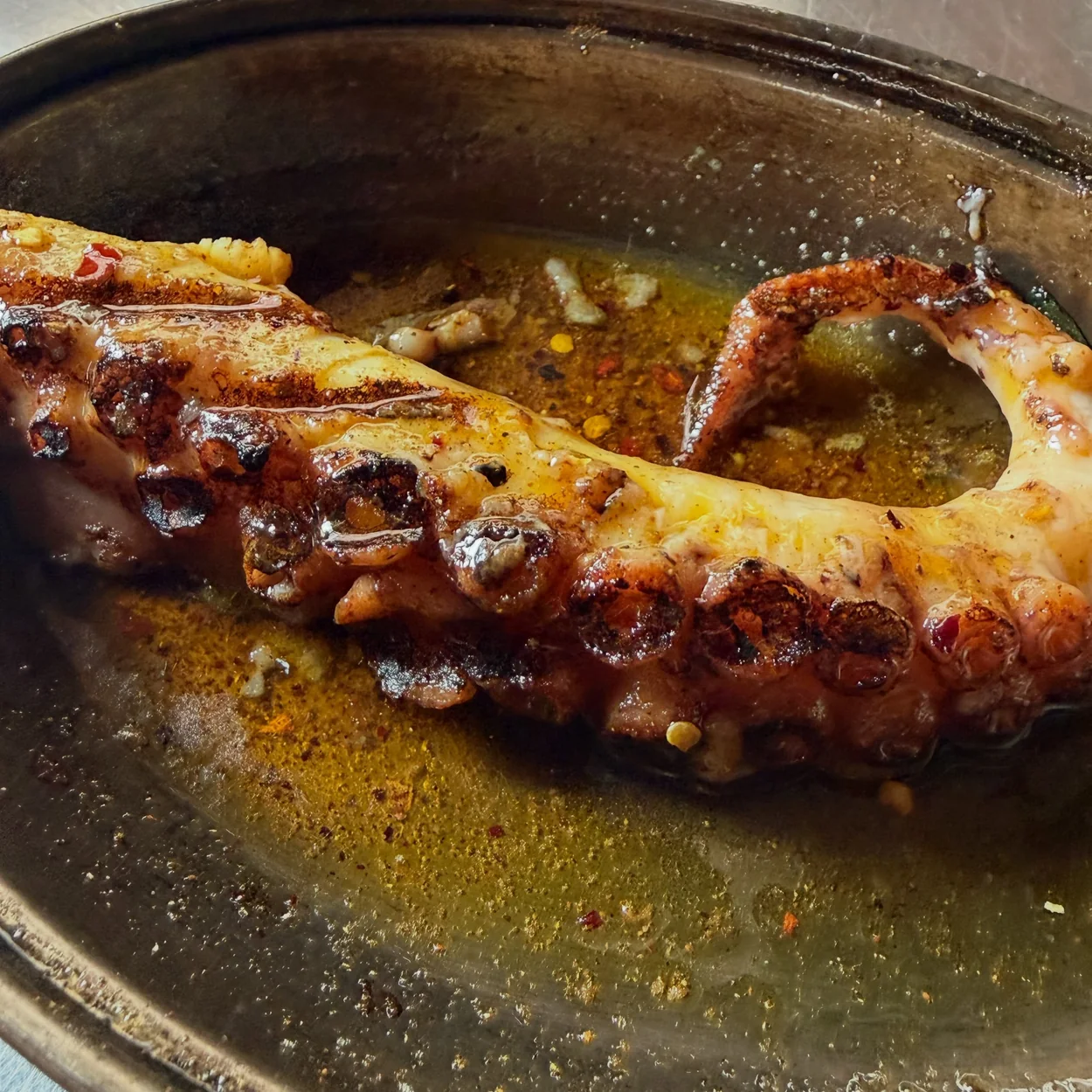 The Barbary grilled octopus tentacle in a copper pan
