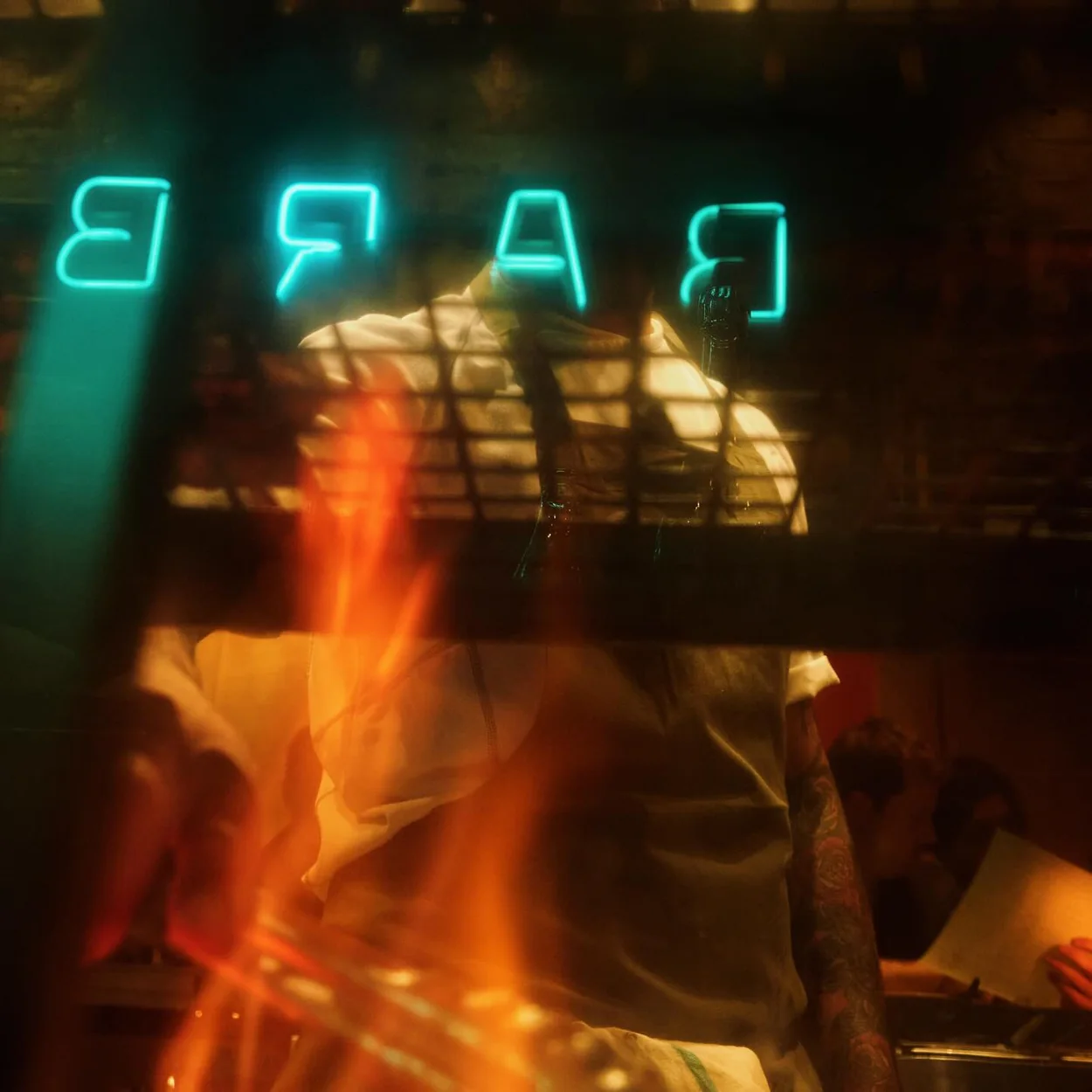 The Barbary neon sign seen through the open-fire grill
