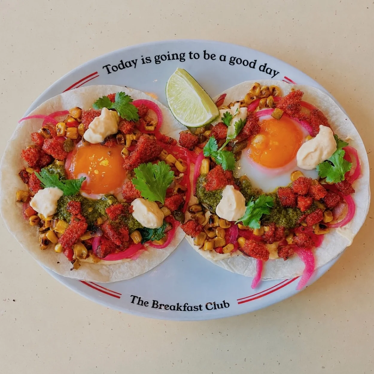 The Breakfast Club huevos rancheros on a branded plate