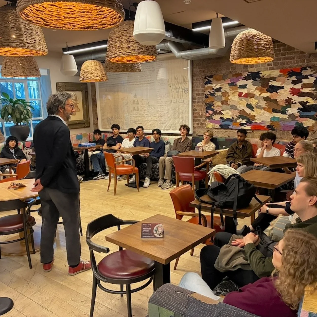 The Conduit members listening to a talk in the lounge