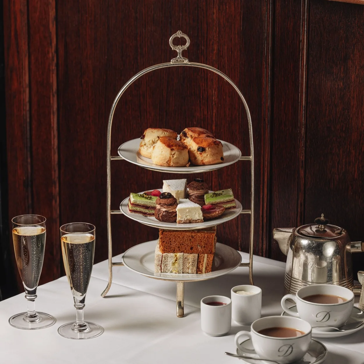 The Delaunay afternoon tea stand with pastries, sandwiches and champagne