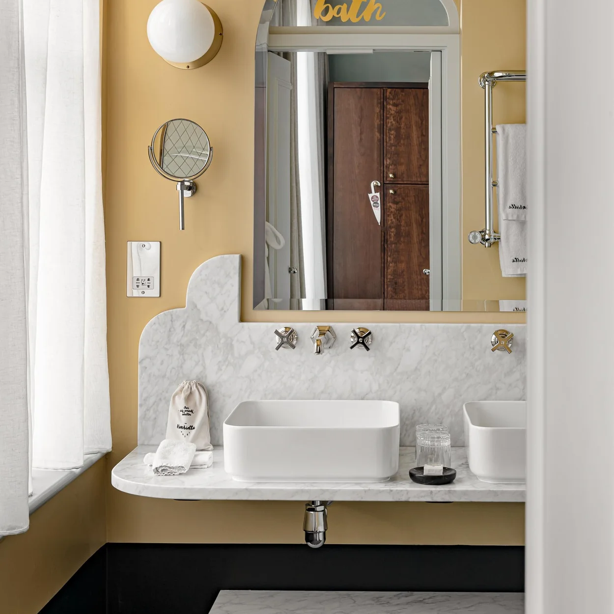 Henrietta Hotel marble bathroom with yellow walls
