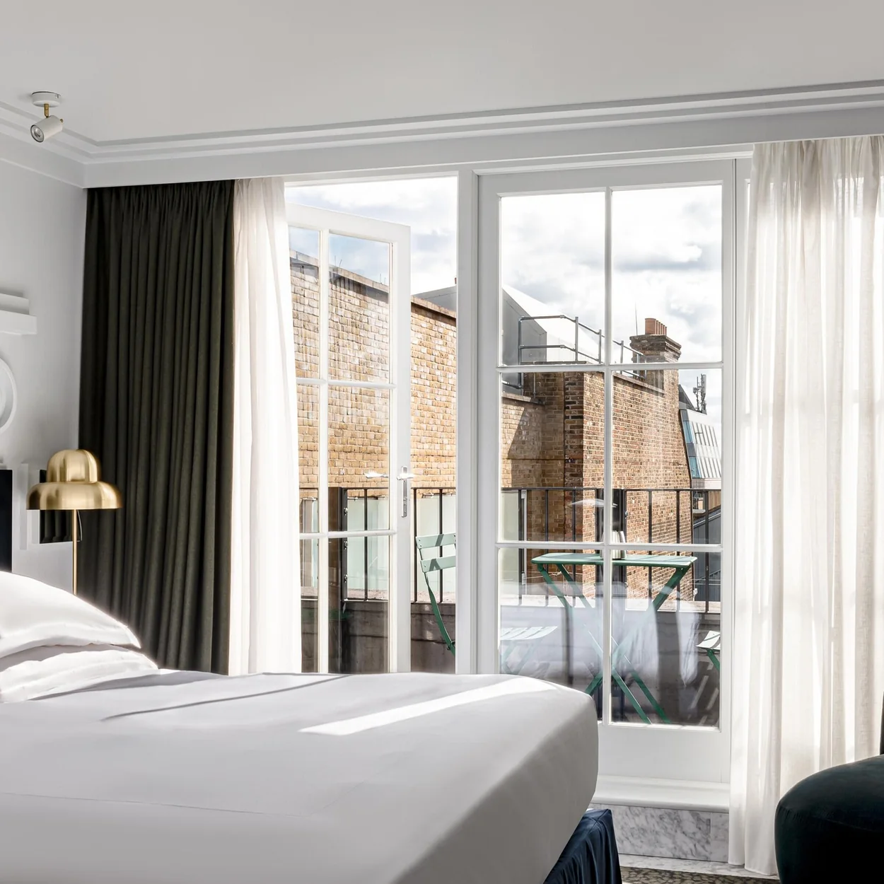 Henrietta Hotel bedroom with tall sash window over Covent Garden rooftops