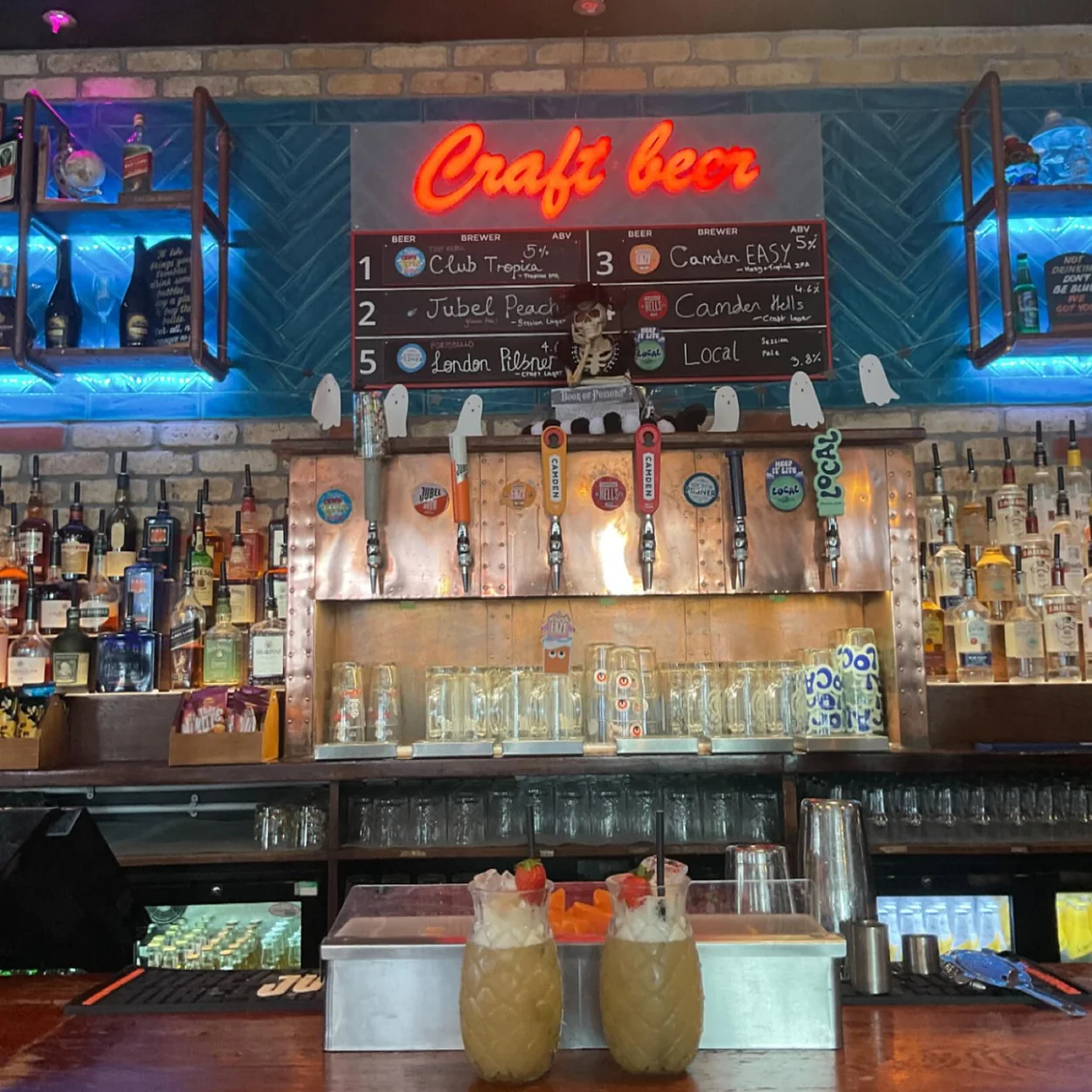 The Long Acre back bar with craft beer board and cocktails
