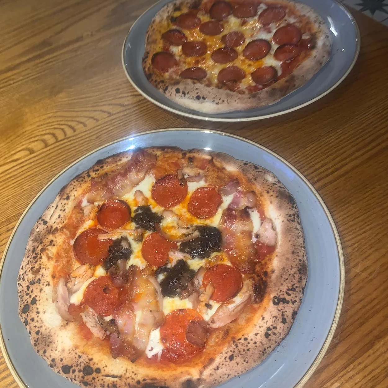 The Long Acre pizzas served on wooden tables