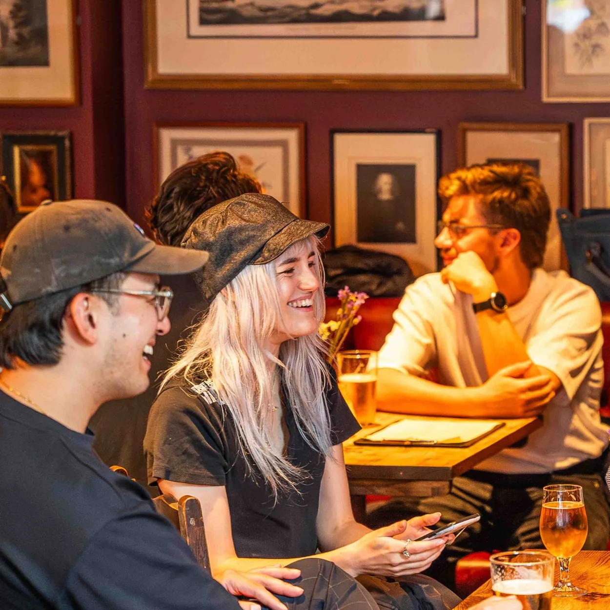 The Marlborough Head guests at a table beneath framed prints
