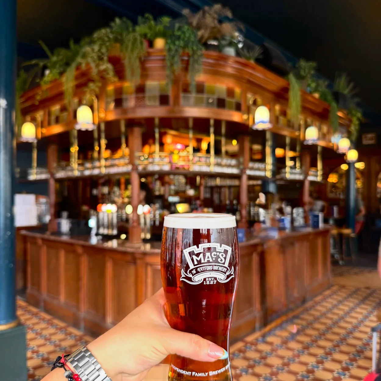 The Nags Head tiled bar interior with a pint of McMullen ale