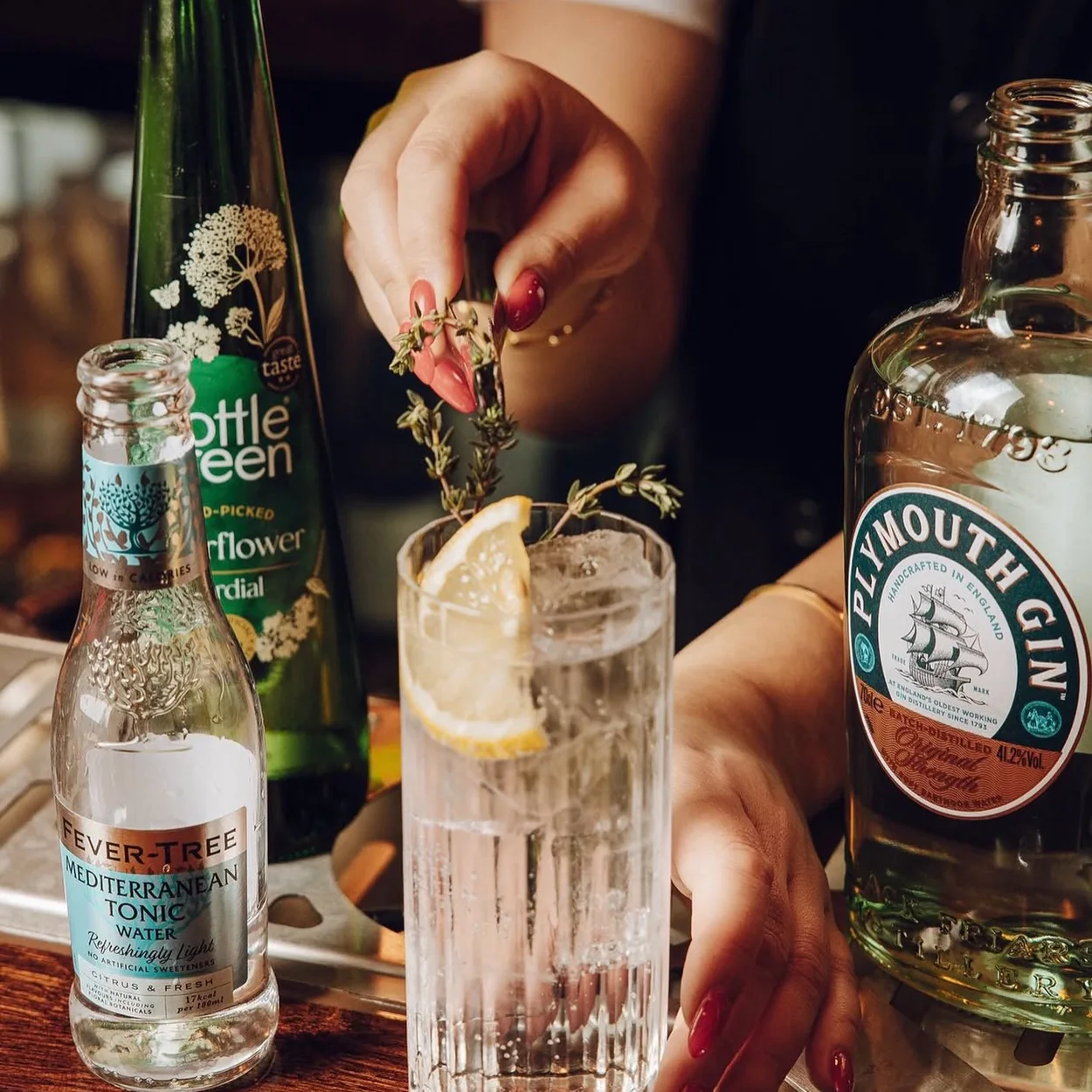 The Nell Gwynne Tavern gin and tonic being garnished at the bar