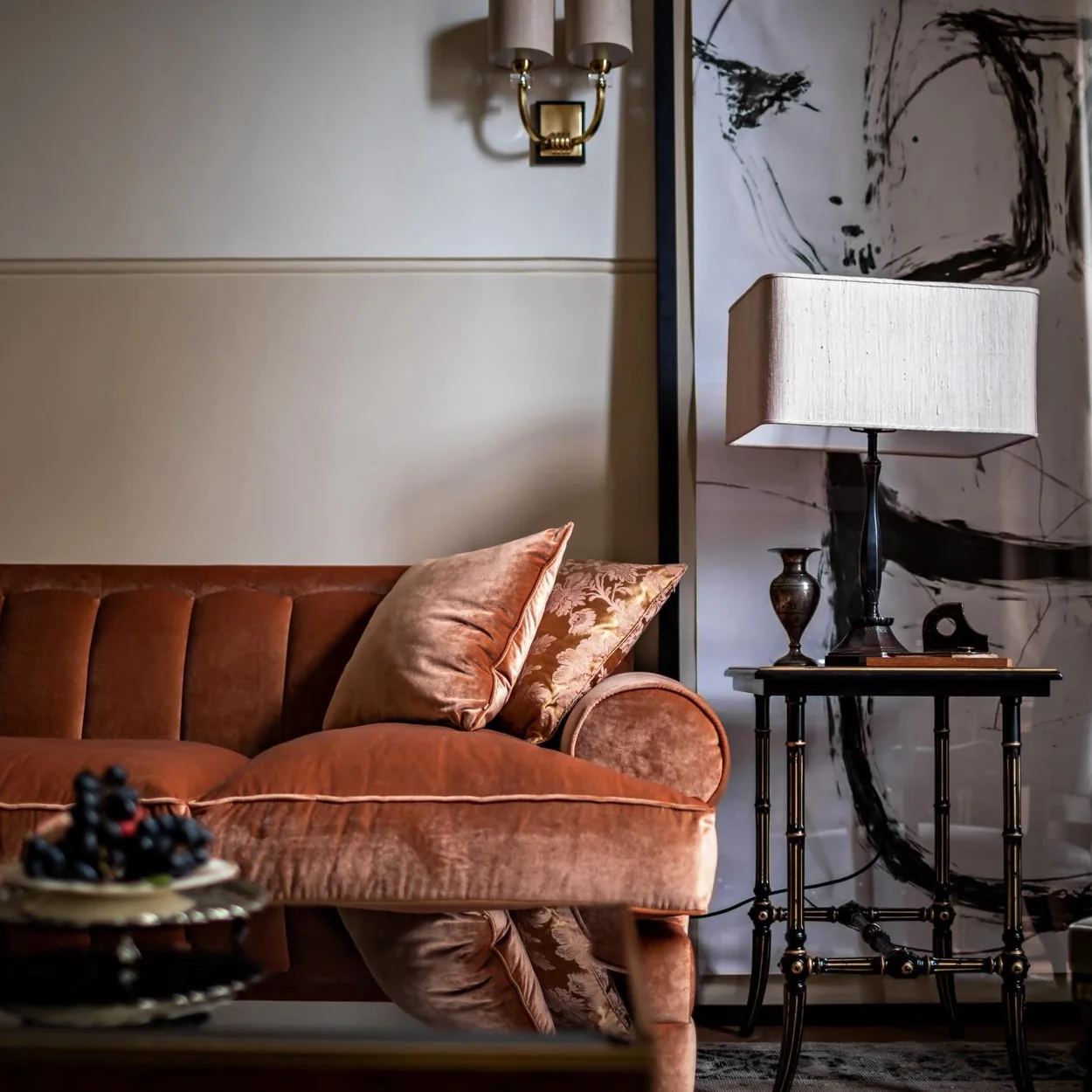 NoMad London lounge with velvet sofa and lamp