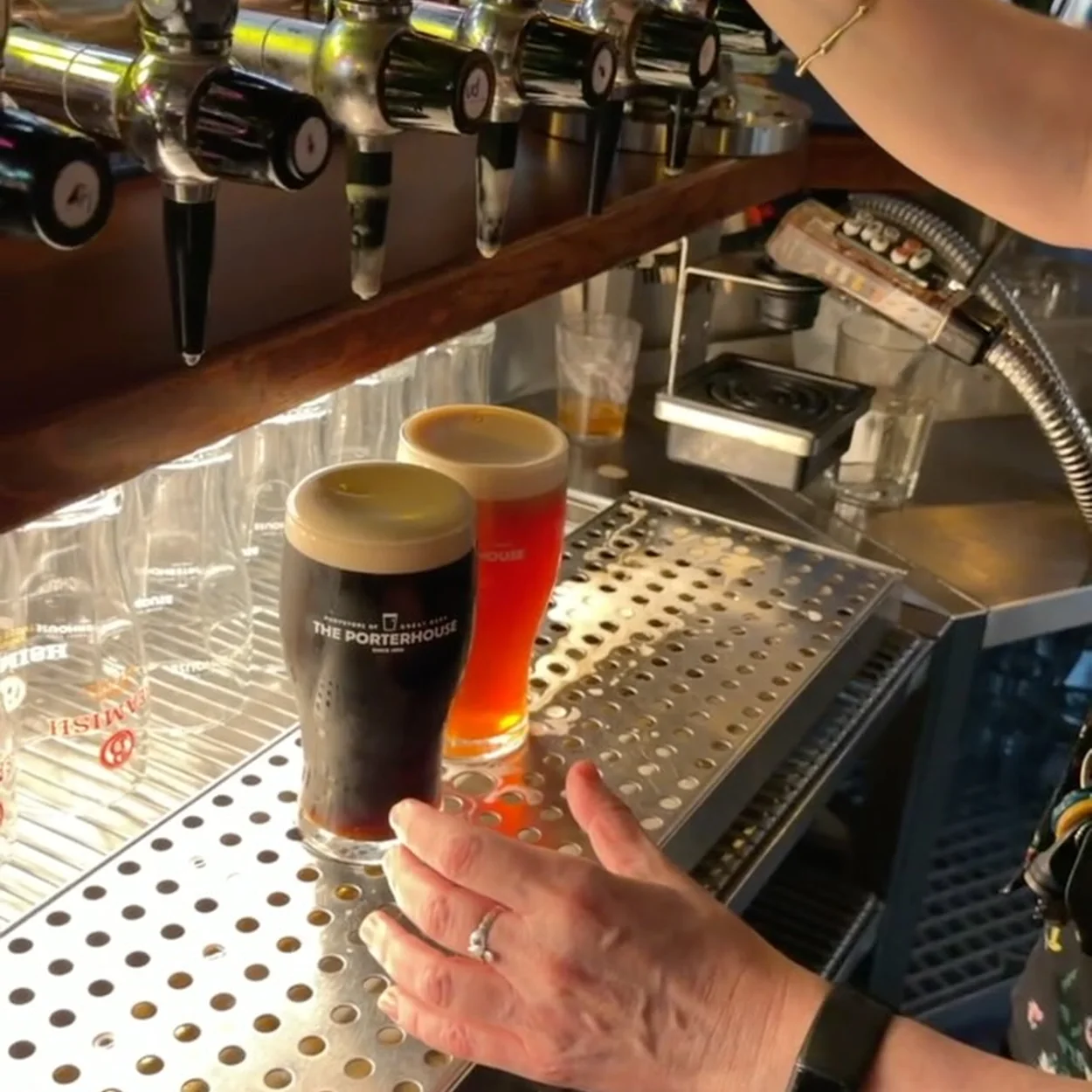 Pints of porter and red ale being poured at the taps of The Porterhouse