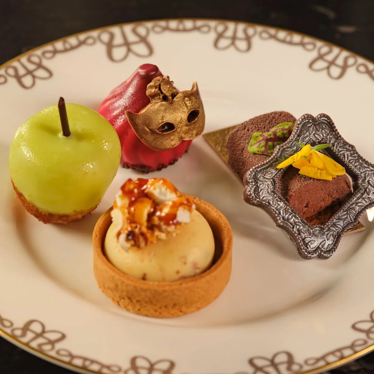 The Waldorf Hilton afternoon tea pastries on a patterned plate in the Palm Court