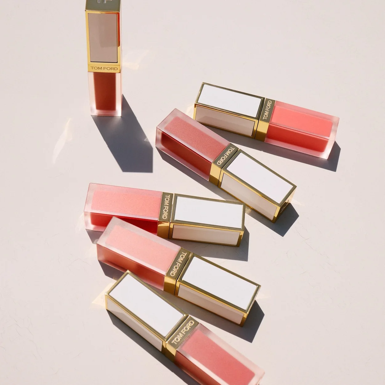 Tom Ford Beauty lip products laid out in summer shades