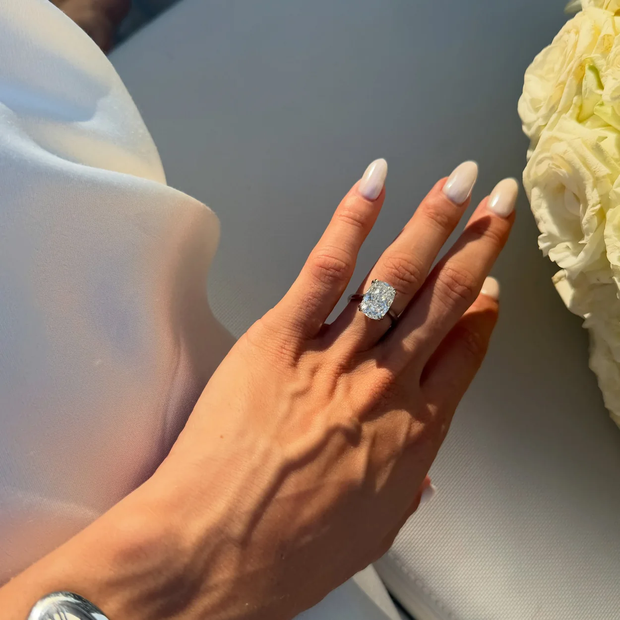 Townhouse short white manicure with a diamond ring and watch