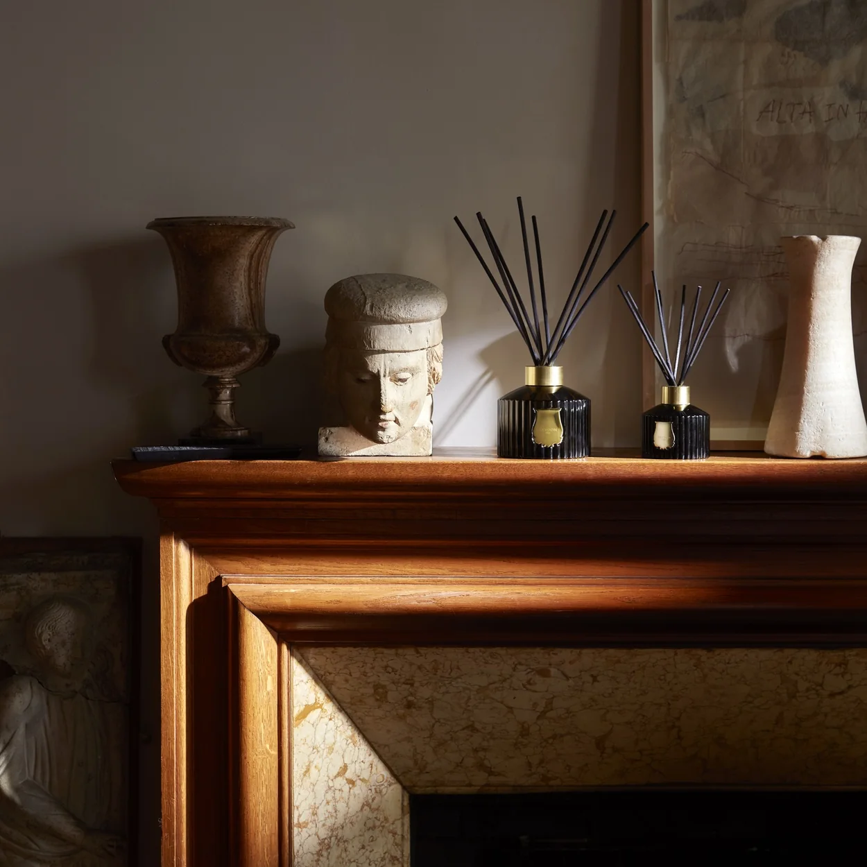 Trudon diffusers on a marble mantelpiece