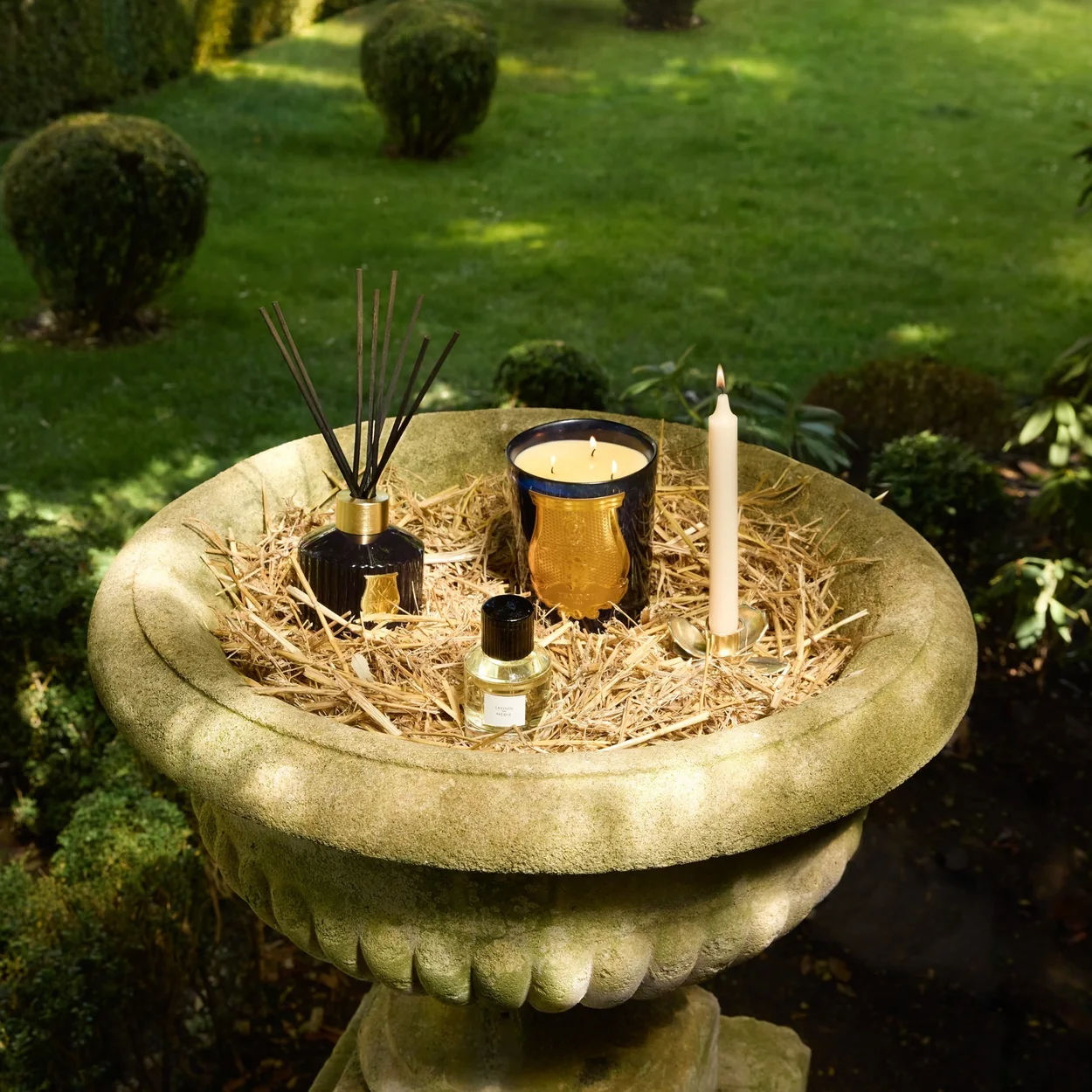 Trudon candle and diffuser in a stone garden urn