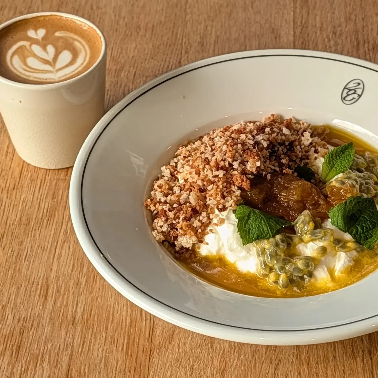 26 Grains porridge bowl with toasted grains and a flat white