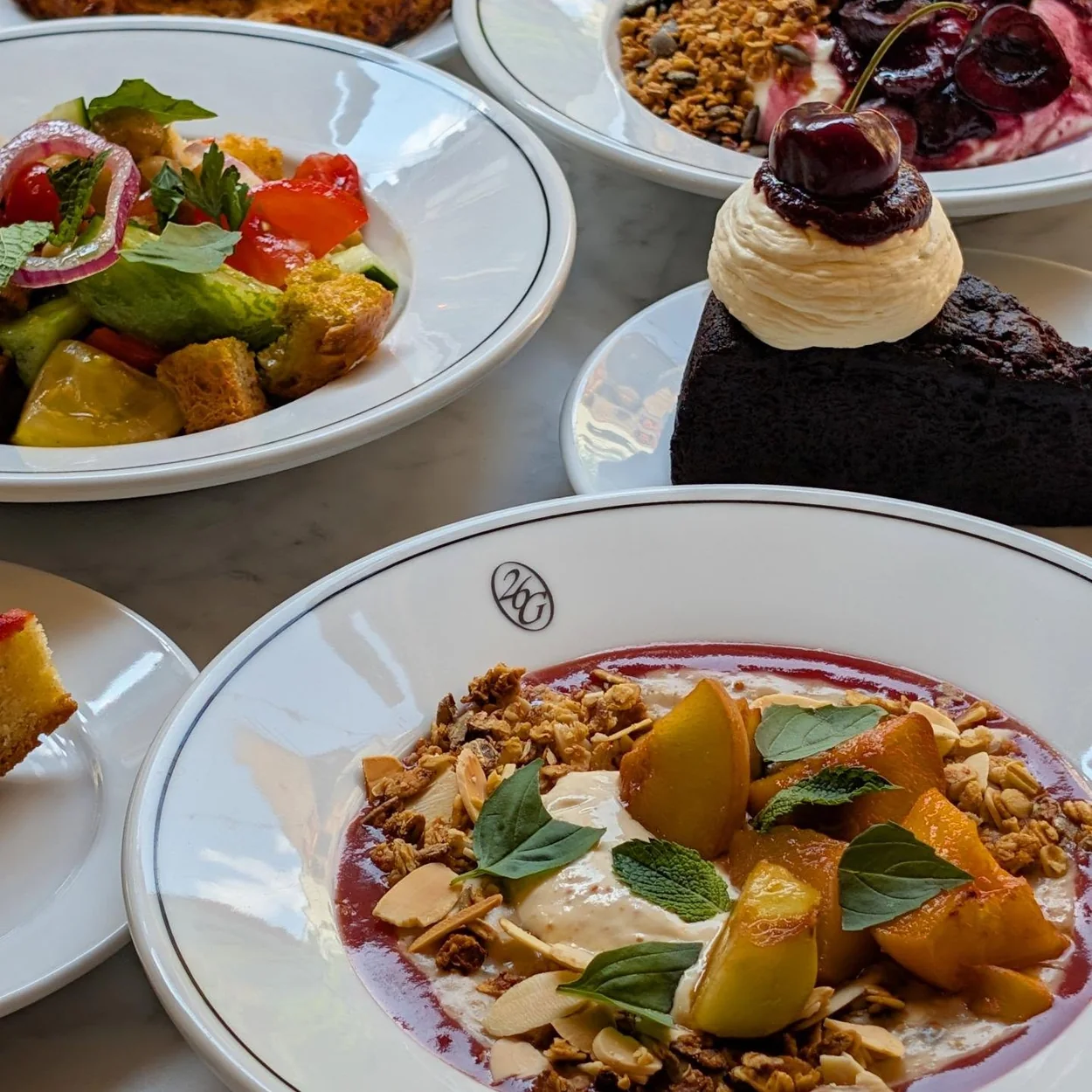 26 Grains breakfast spread of bowls, fruit and cake