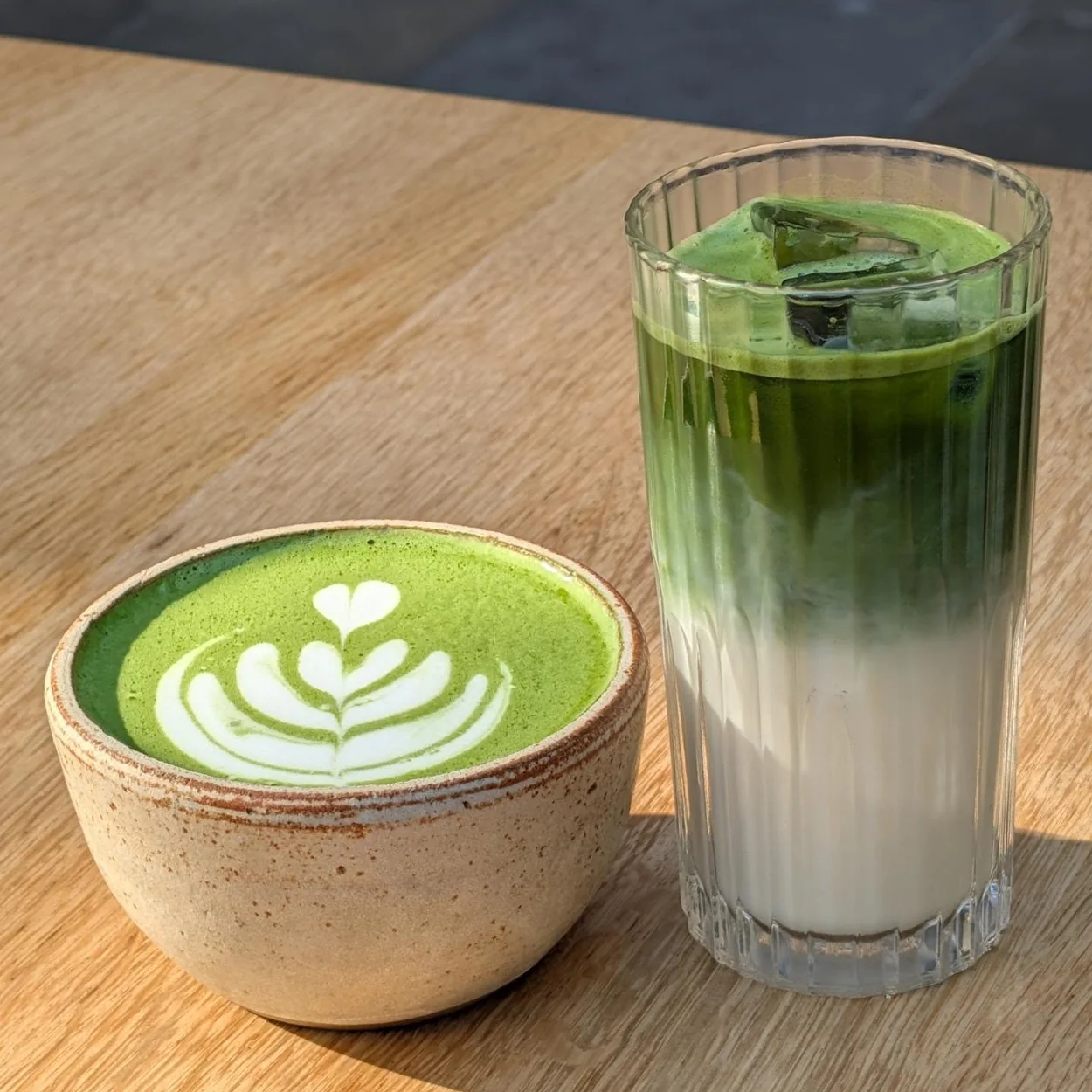 26 Grains matcha latte and iced matcha on a wooden table
