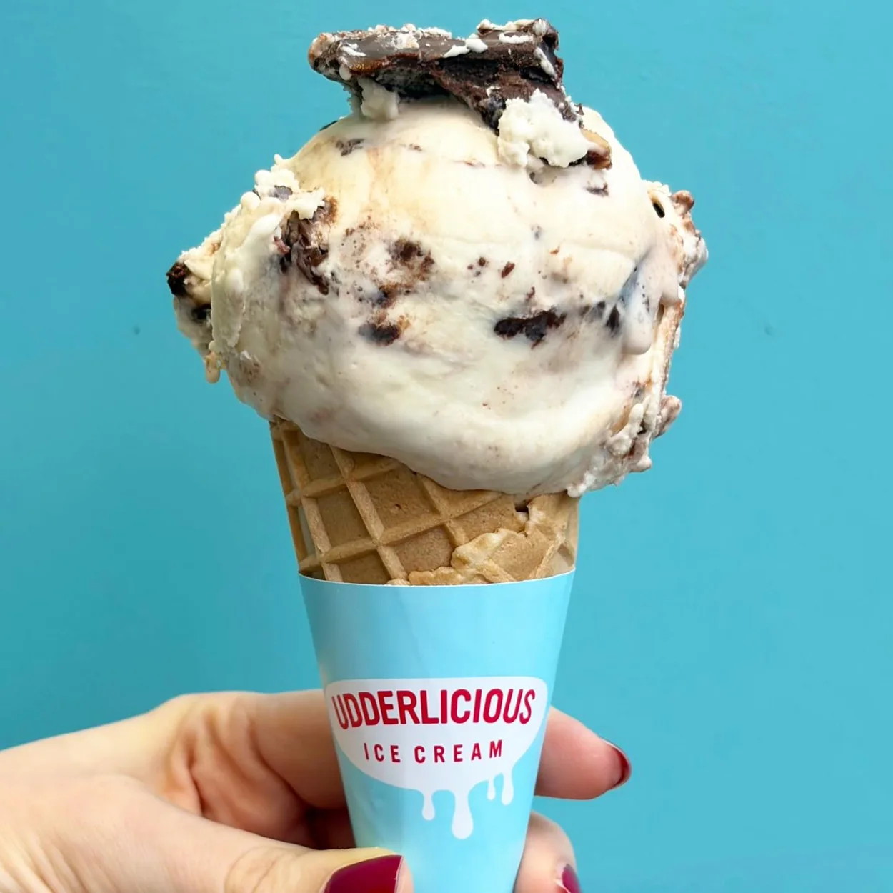 Udderlicious cookies and cream scoop in a waffle cone