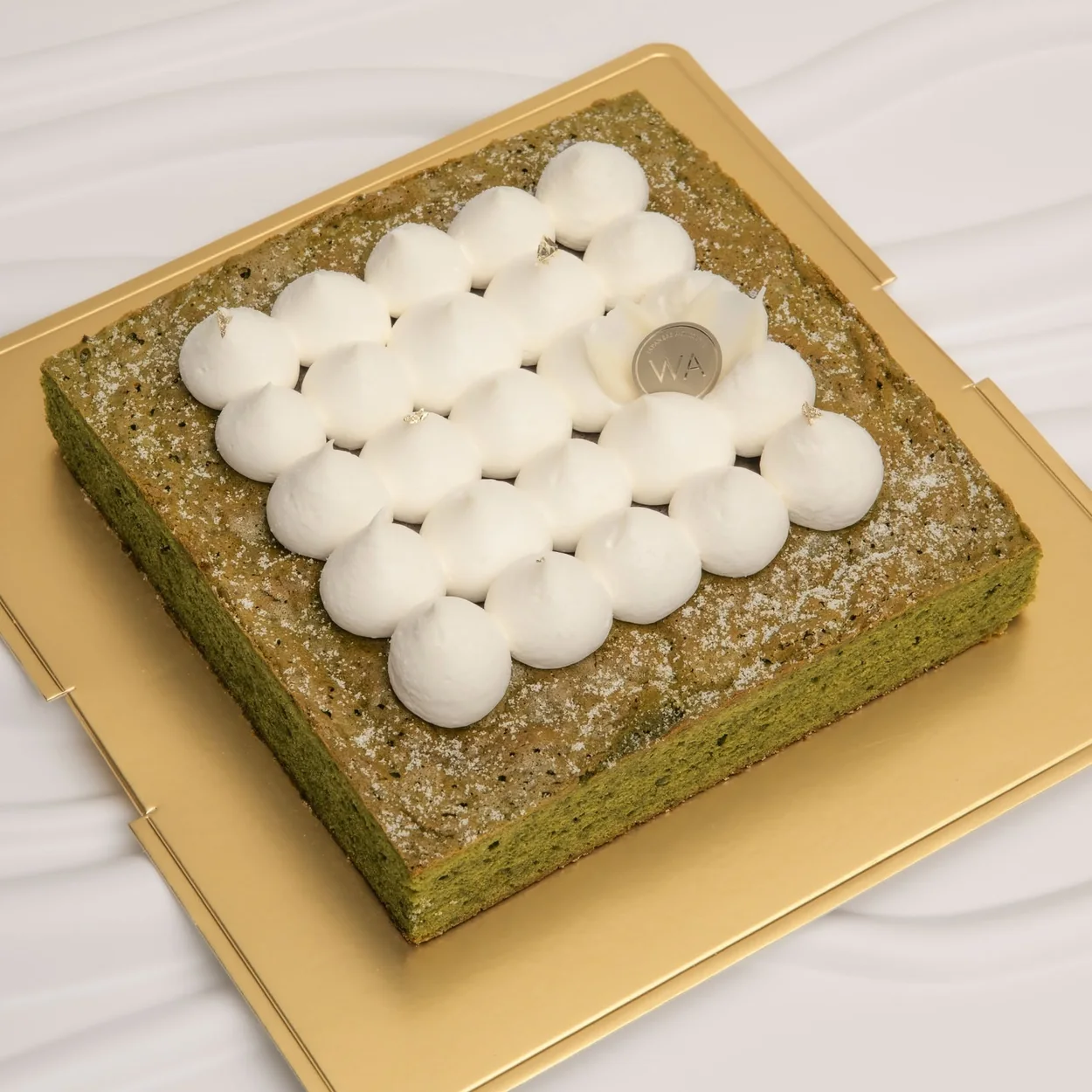 WA Bakery square matcha cake topped with piped cream