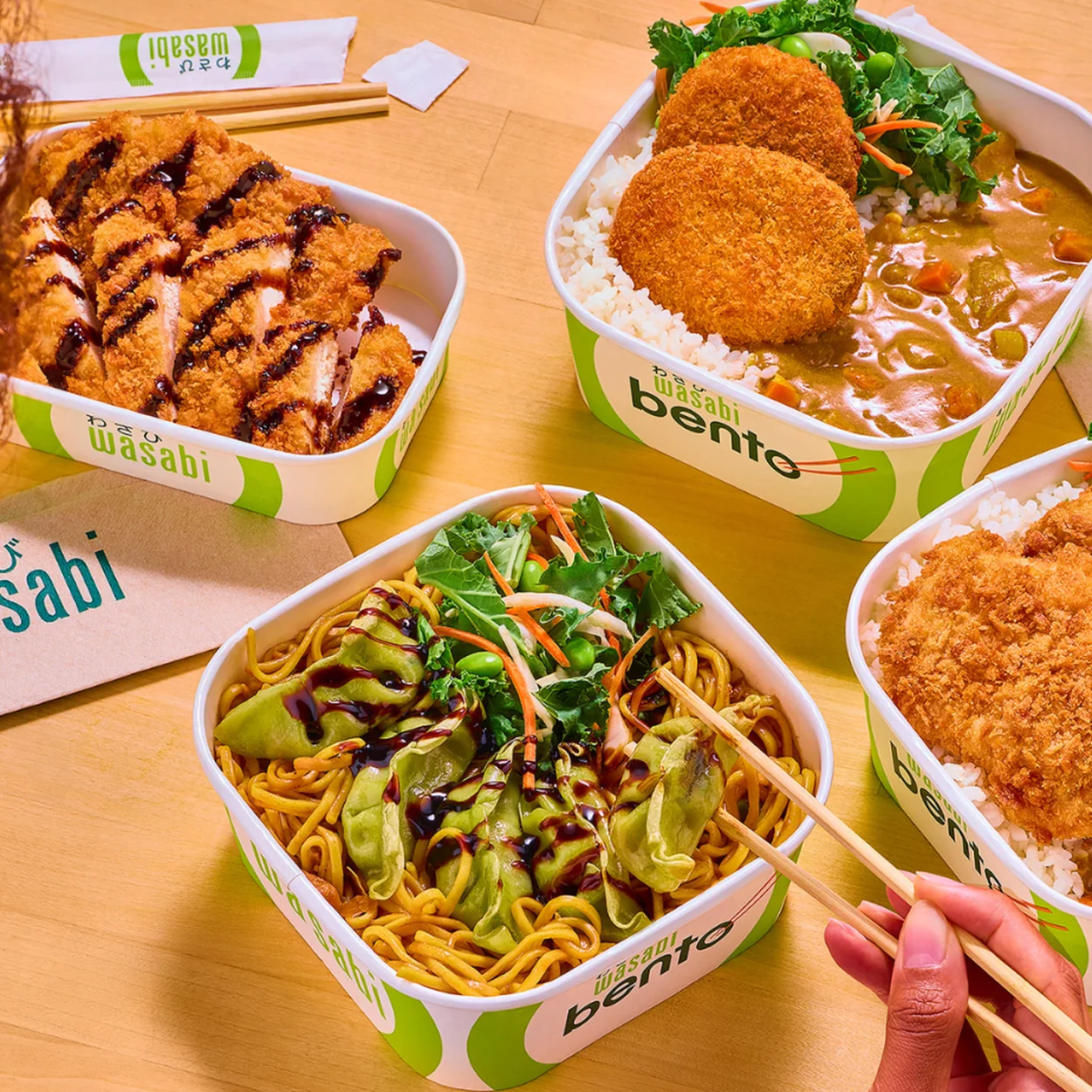 Wasabi Sushi & Bento hot bento boxes and katsu curry on a table
