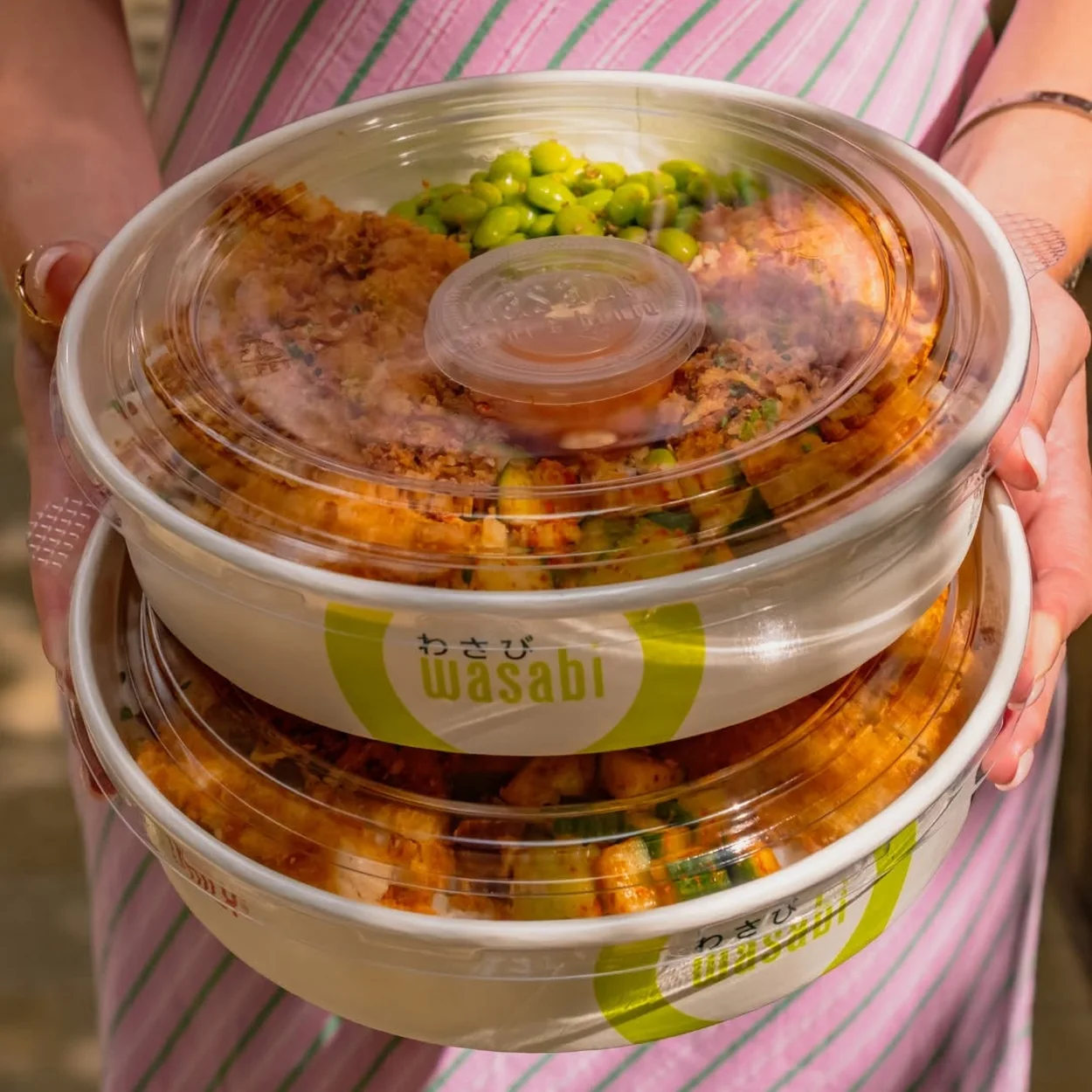 Wasabi Sushi & Bento takeaway bowls in branded packaging