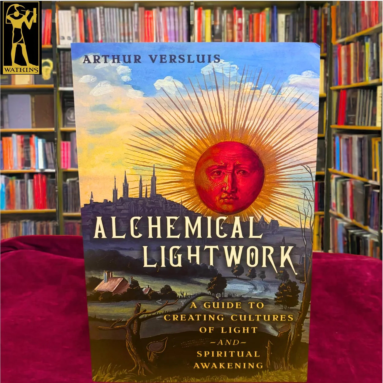 Watkins Books copy of Alchemical Lightwork in front of the shelves