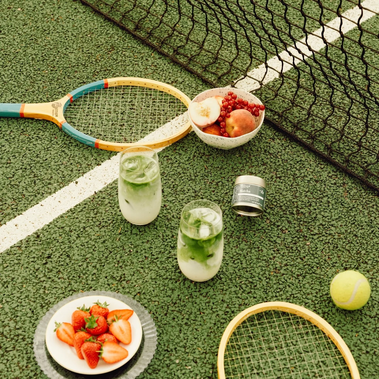 Whittard of Chelsea iced teas with strawberries on a tennis court