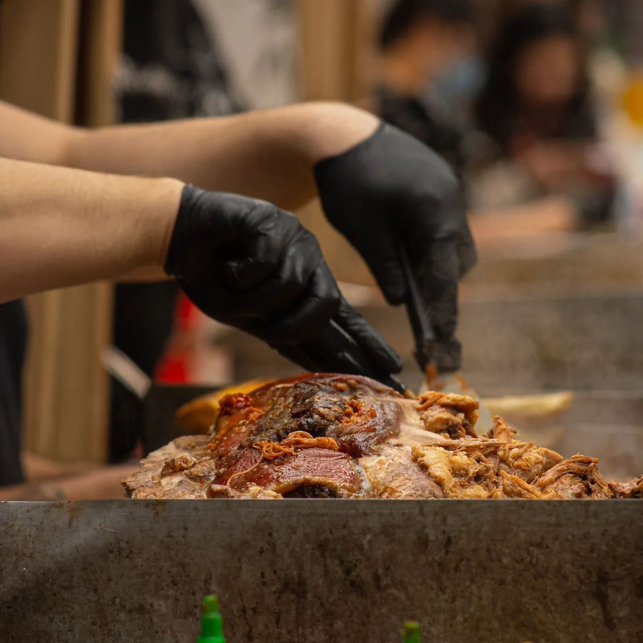 Staff member preparing meat on the griddle at Dirty Bagels