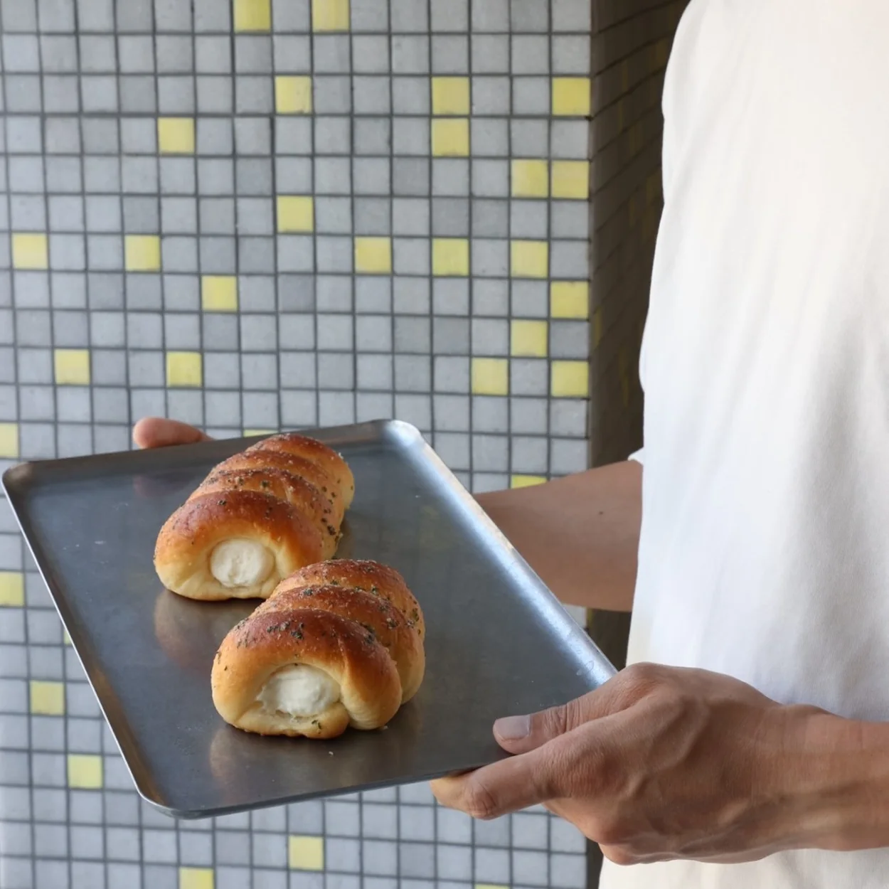 Freshly baked buns carried on a tray at HOKO Wonton Noodles