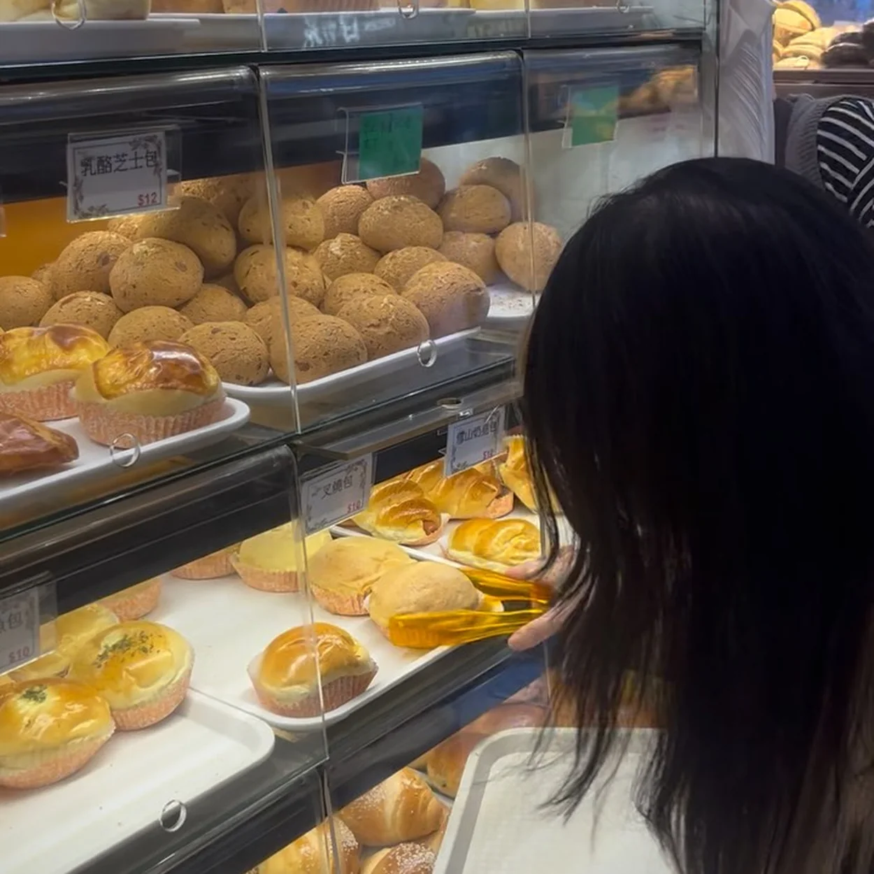Counter display of baked buns and pastries at HOKO Wonton Noodles