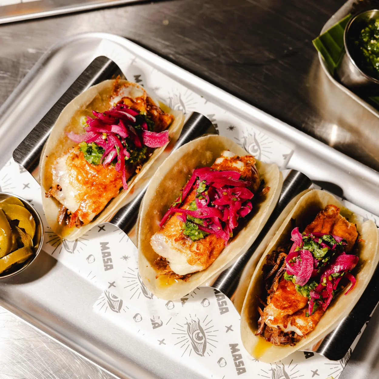 MASA Tacos with pickled onion in a serving tray